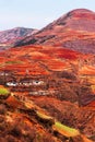 Stunning scenery landscape of wheat terraces and ancient village on the high mountains, Ã¢â¬ÅRed LandÃ¢â¬Â of Dongchuan, China